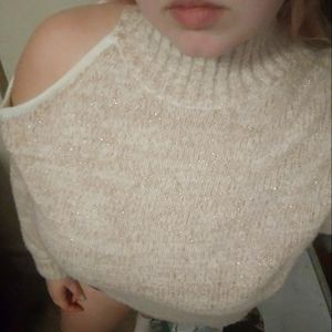 Glittery sweater with cutout shoulder.